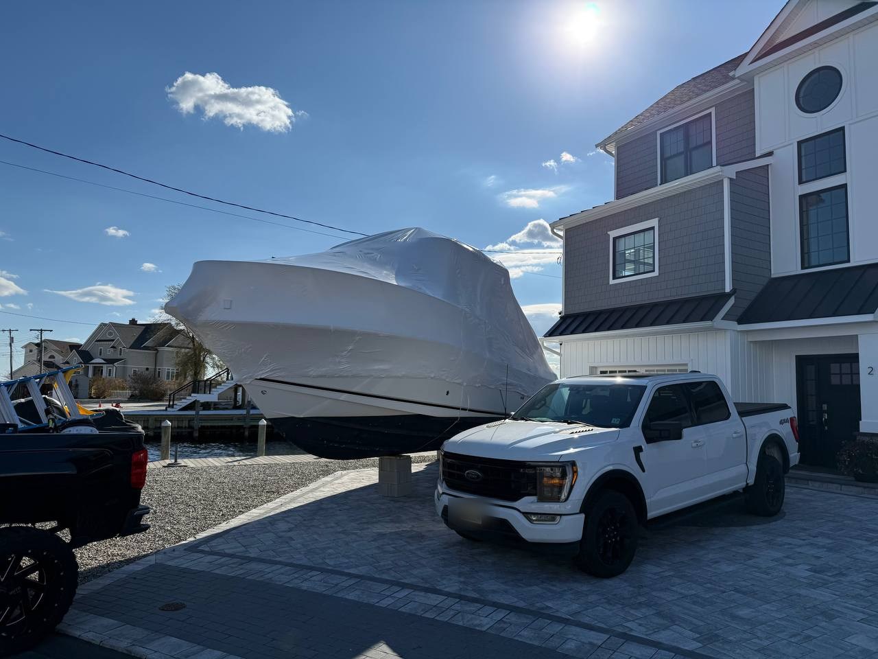 Boat shrink wrapped on a lift
